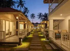 Follow the inviting walkway to a picturesque beach house, where a welcoming porch and a tranquil patio beckon you to unwind and enjoy the coastal breeze.