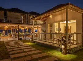 Discover a picturesque house illuminated by the moonlight, showcasing a delightful patio and a wooden deck, inviting you to unwind.