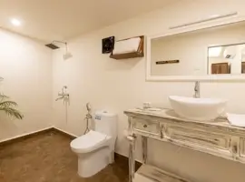 A modern bathroom with a sleek toilet, a stylish sink, and a large mirror reflecting elegance and functionality.