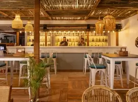 A cozy restaurant with rustic wooden tables and chairs. A perfect place to enjoy a delicious meal with friends and family.