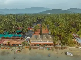 Escape to paradise: an arial view of Mosh by the Shore, nestled amidst palm treas, promising a tranquil getaway by the sea.