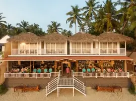 Discover the ultimate beach-side retreat, where thatched roofs blend seamlessly with the stunning surroundings. Indulge in refreshing drinks at the resort's vibrant bar.