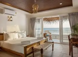 Exquisite bedroom adorned with a luxurious bed and a balcony that presents a mesmerizing view of the vast ocean.